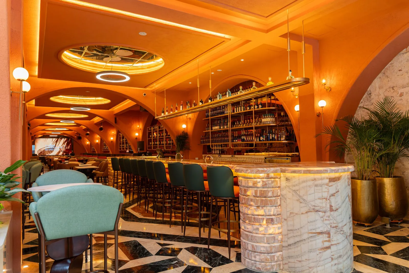 Lit onyx bar and arched dining room at KarMaiRí