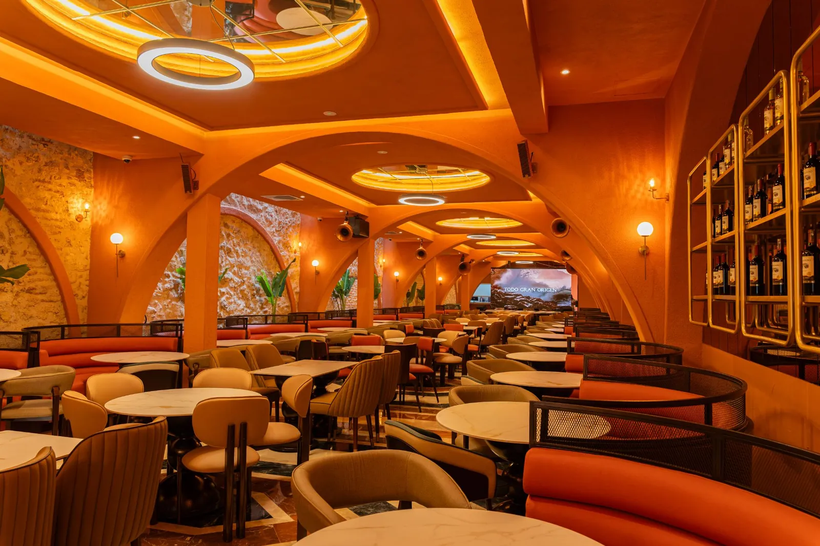 Main dining room tables under arches and round lamps