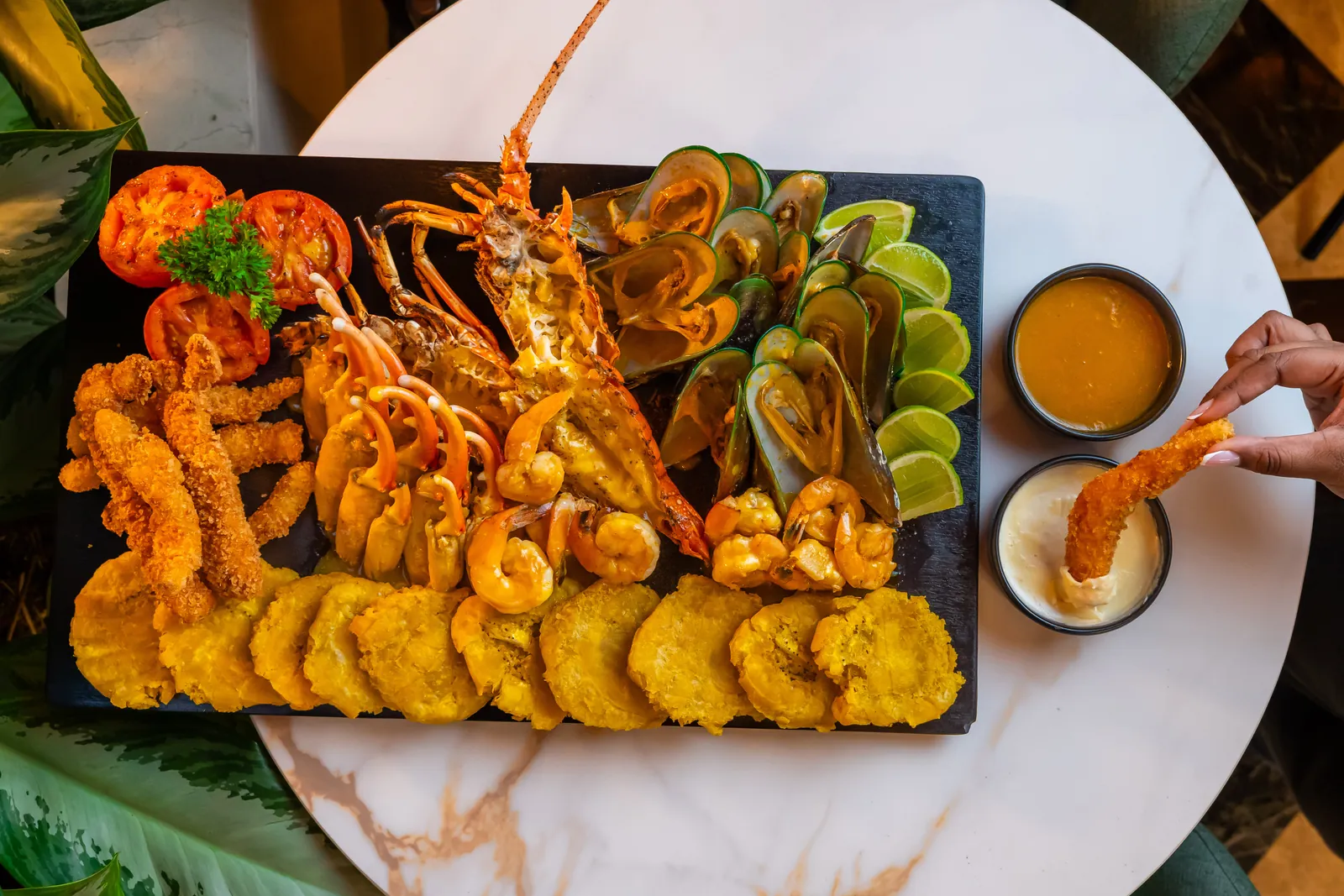 Seafood platter to share with lobster, mussels, prawns and patacones